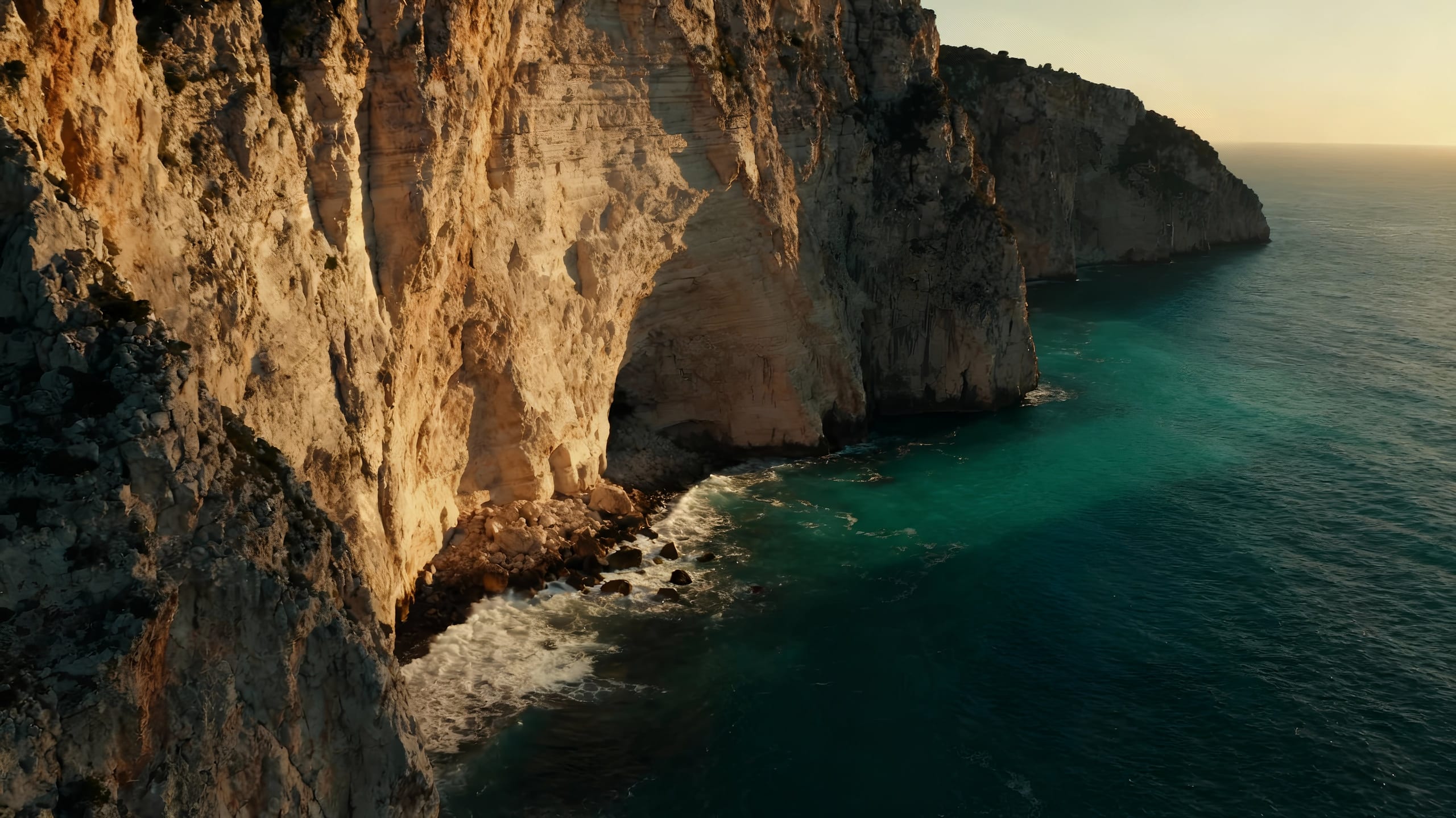 Cliffs over the Mediterranean Sea at dusk.
